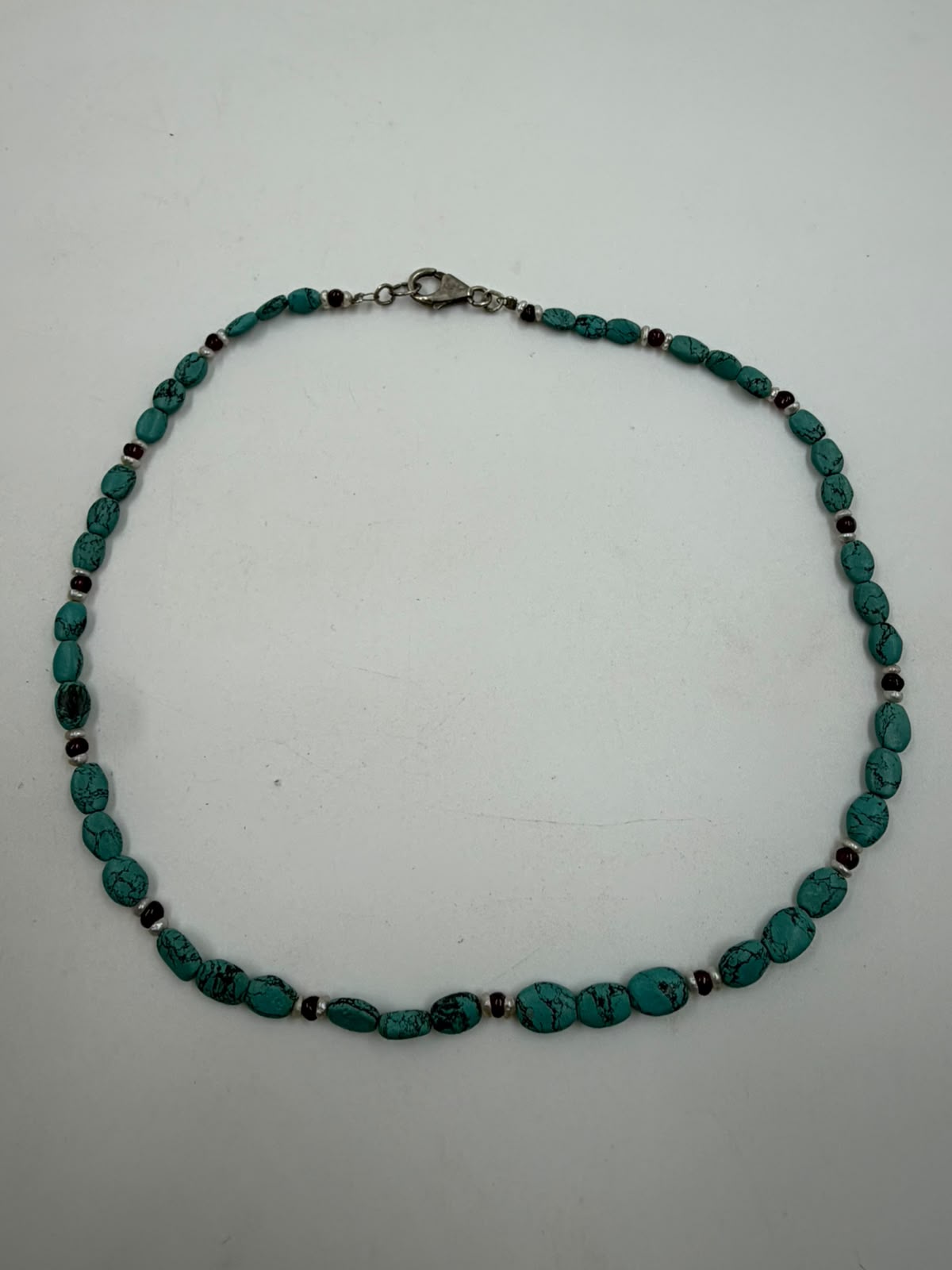 Turquoise nugget necklace close-up showing vivid blue color with dark matrix pattern