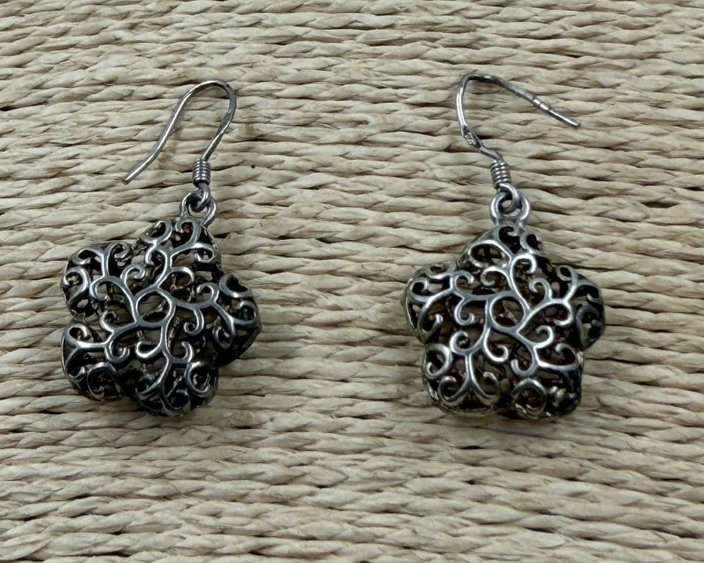 925 silver filigree flower earrings pair lifestyle photo showing oxidized silver finish in warm light