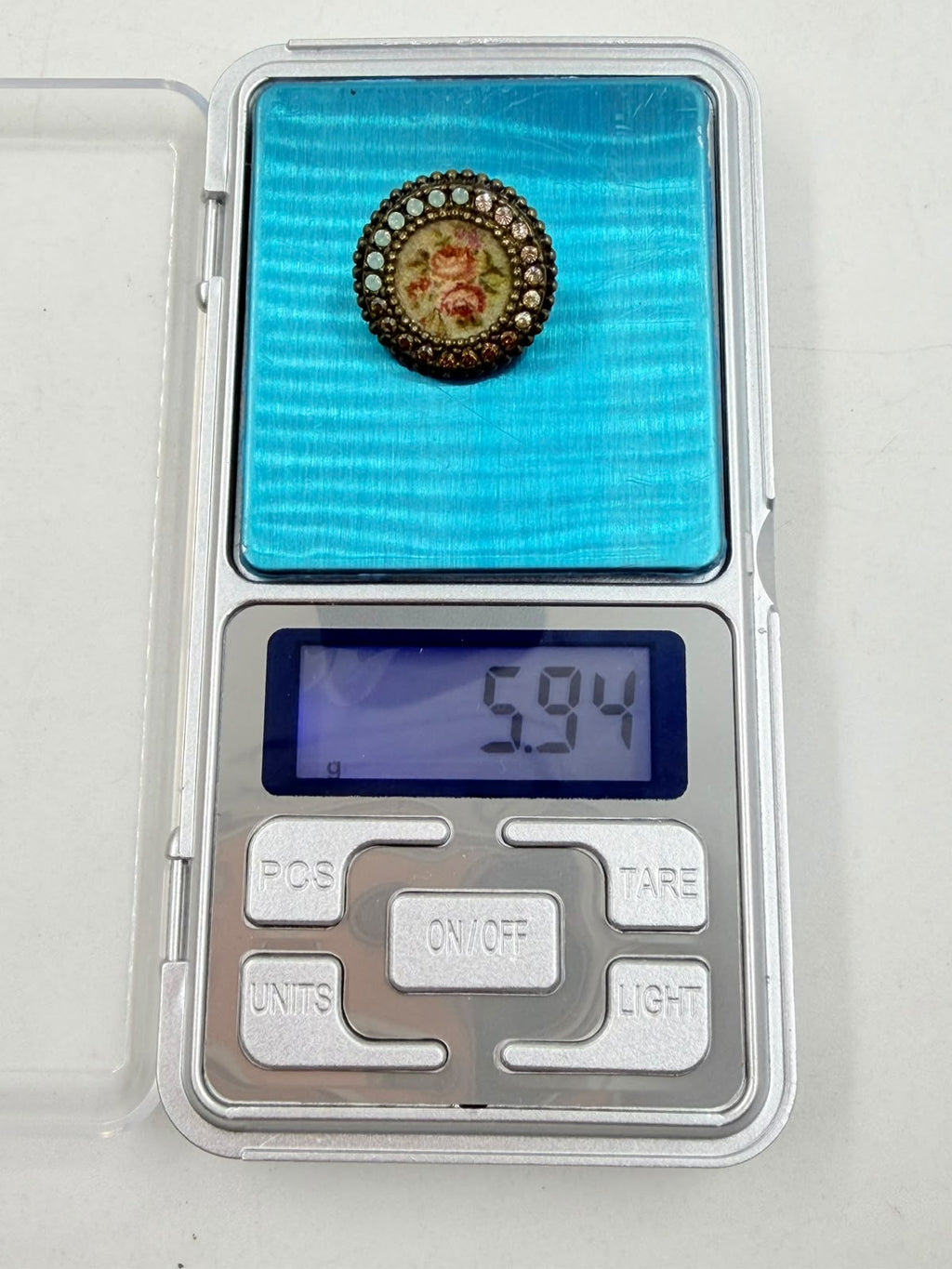 Brooch on woven background front view