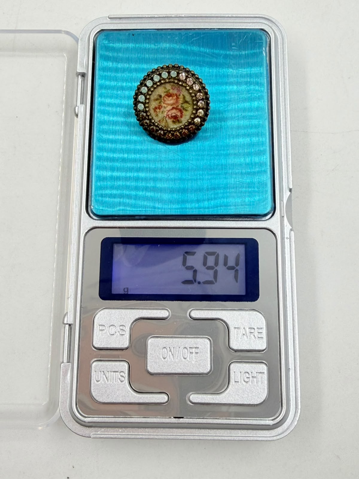 Brooch on woven background front view