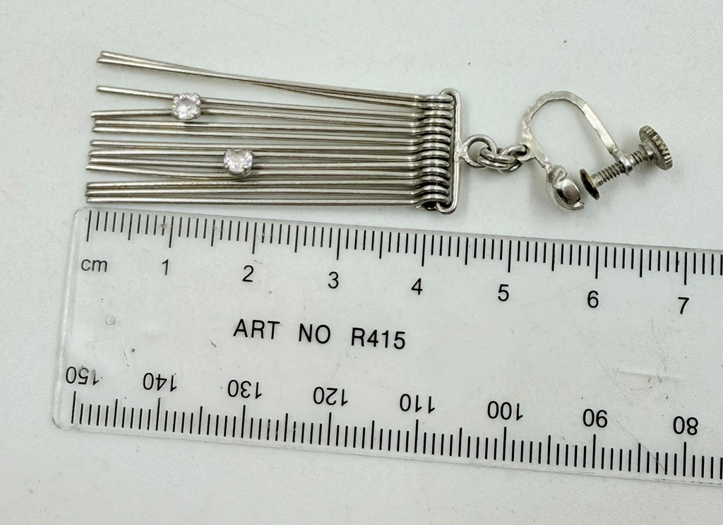 Earring next to ruler showing approx 6-7cm total length