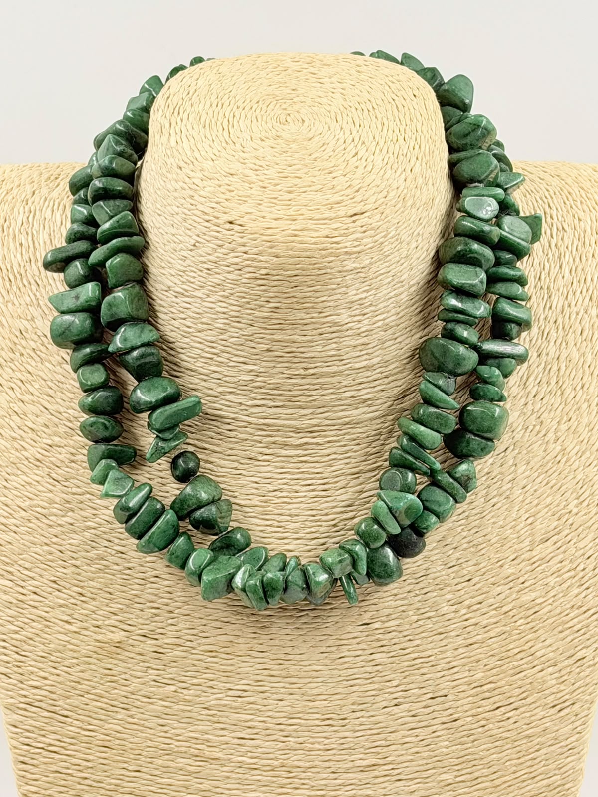 Green aventurine chip necklace on wicker bust - single strand close up