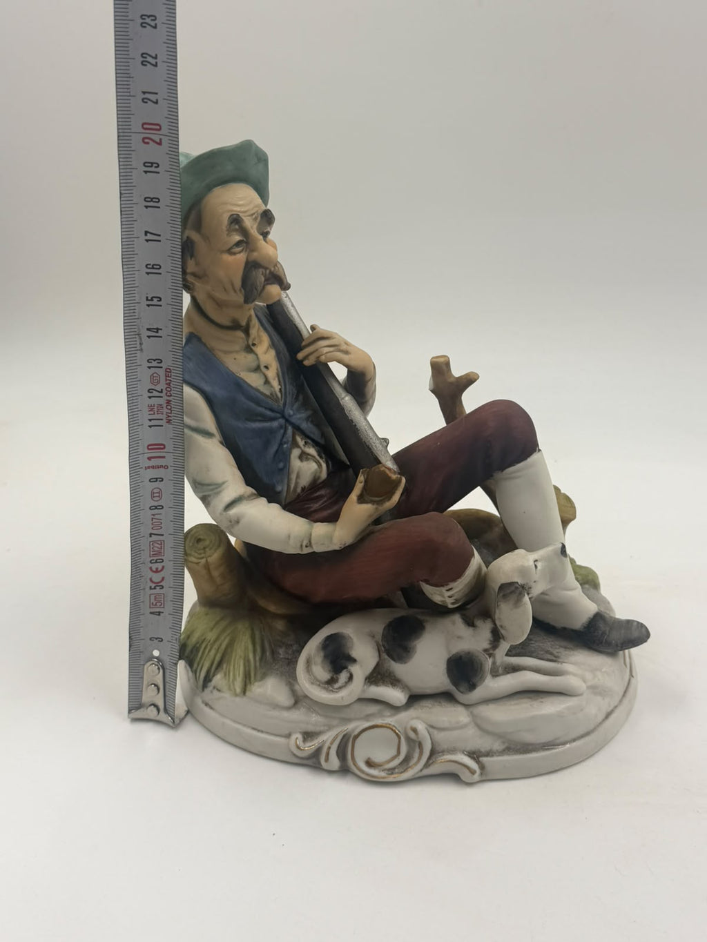 Vintage Capodimonte flute player figurine three-quarter view