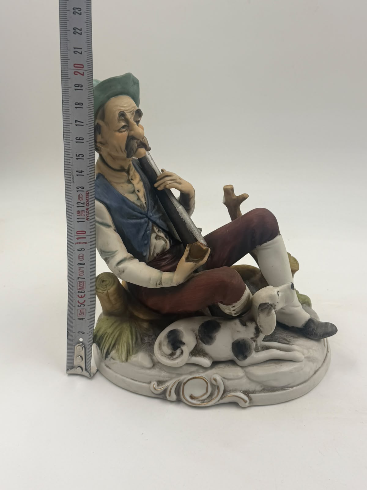 Vintage Capodimonte flute player figurine three-quarter view