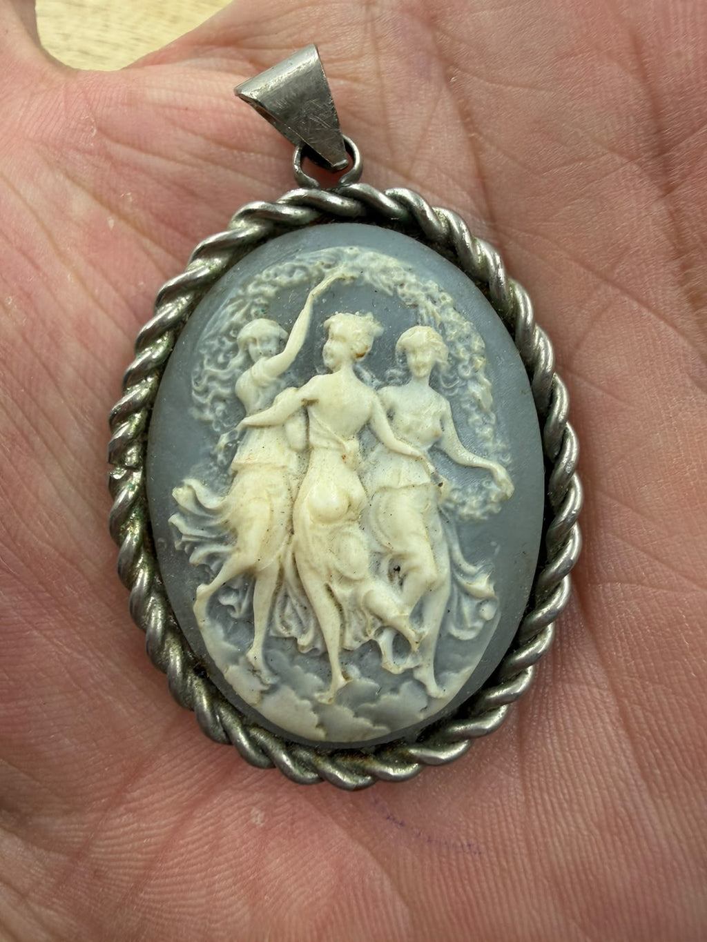 925 silver Three Graces cameo pendant lifestyle held showing size scale and oxidized silver rope frame patina