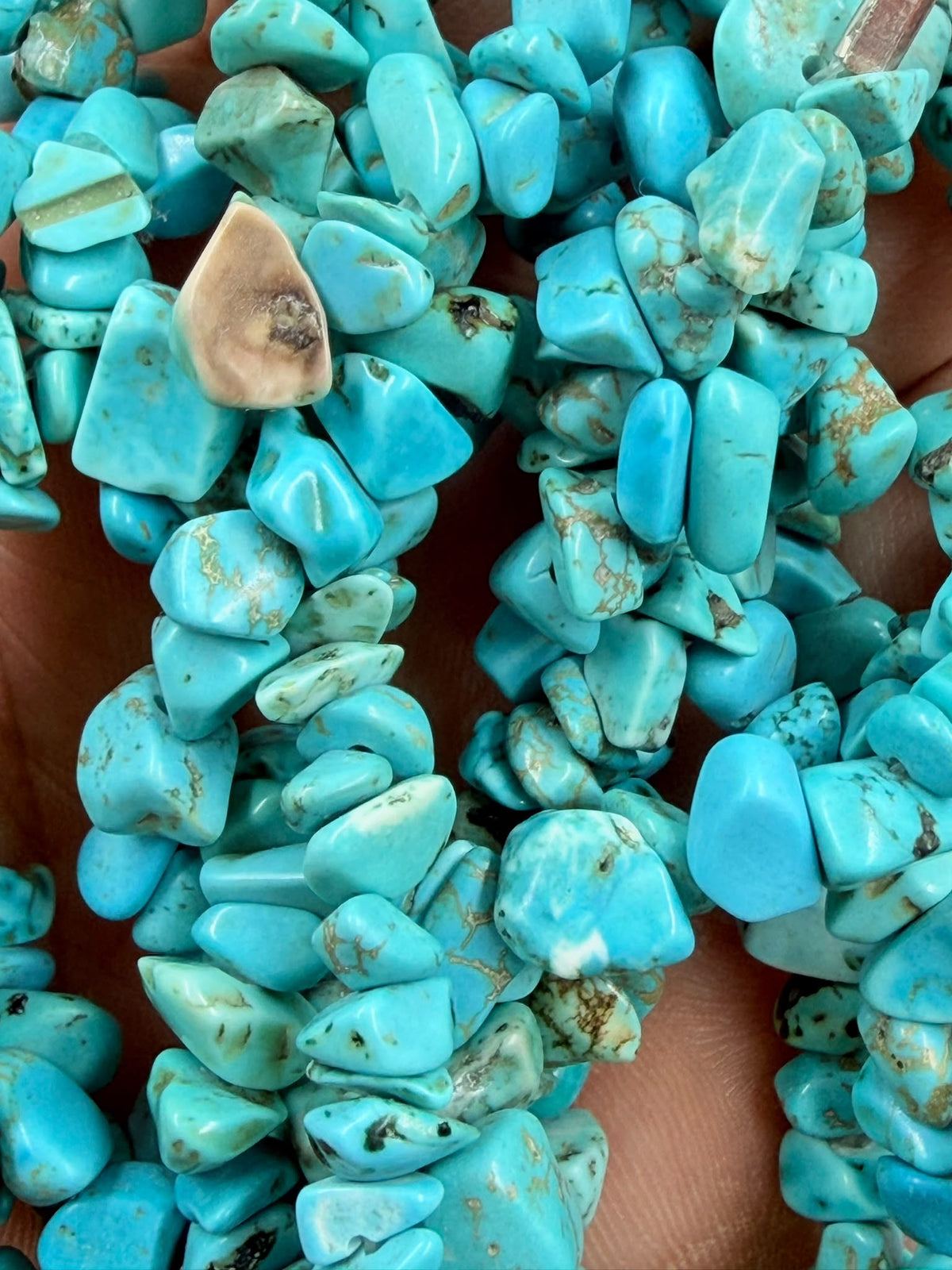 Triple strand turquoise necklace on jewelry display bust