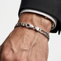 Men's sterling silver Figaro chain bracelet worn on wrist
