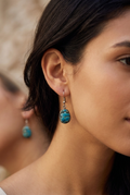 Woman wearing vintage Egyptian turquoise faience scarab drop earrings
