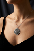 Woman wearing sterling silver Medusa medallion pendant necklace