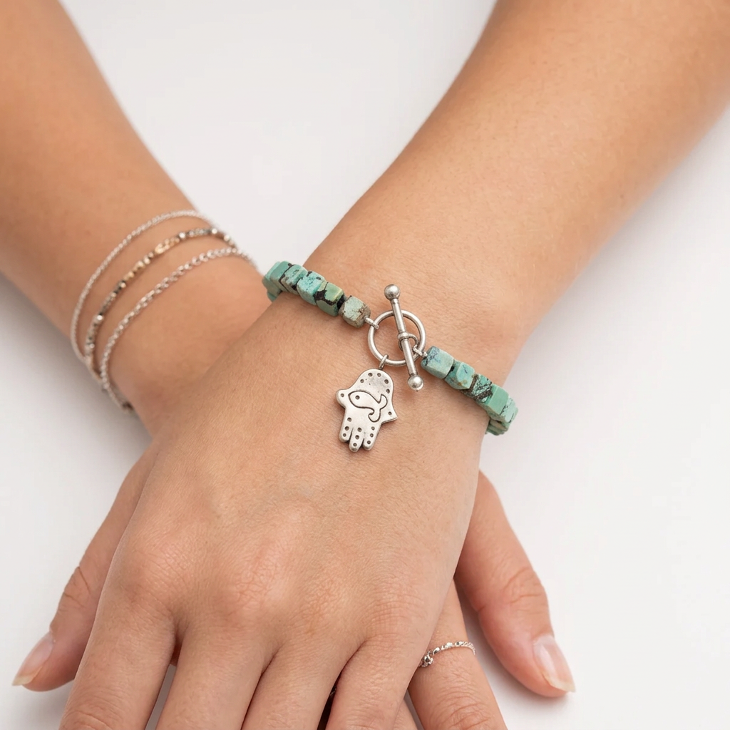 Natural turquoise bracelet with Hamsa charm worn on wrist