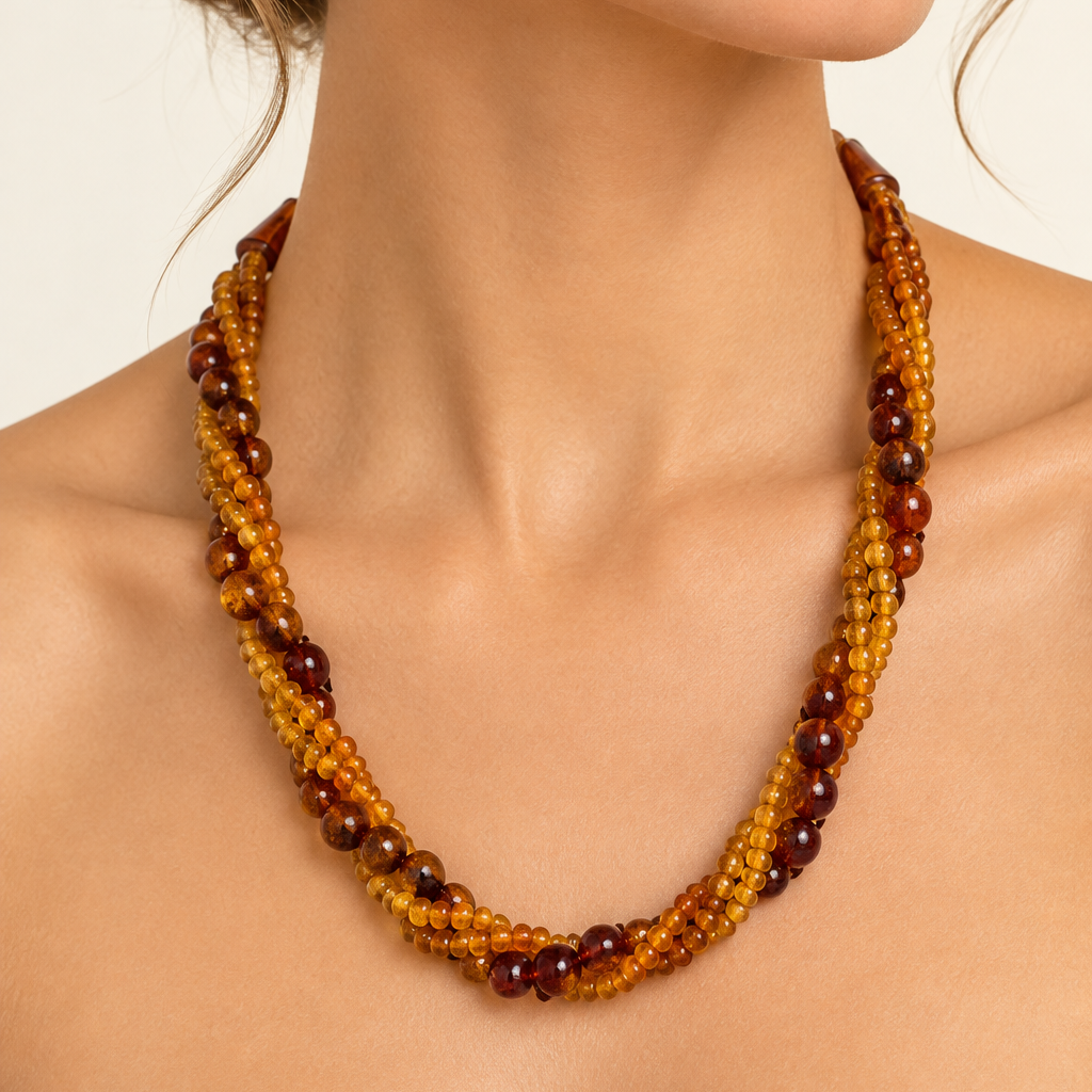 Vintage Baltic amber triple-strand necklace worn on woman's neck