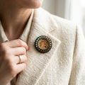 Vintage floral miniature brooch worn on woman's lapel lifestyle photo